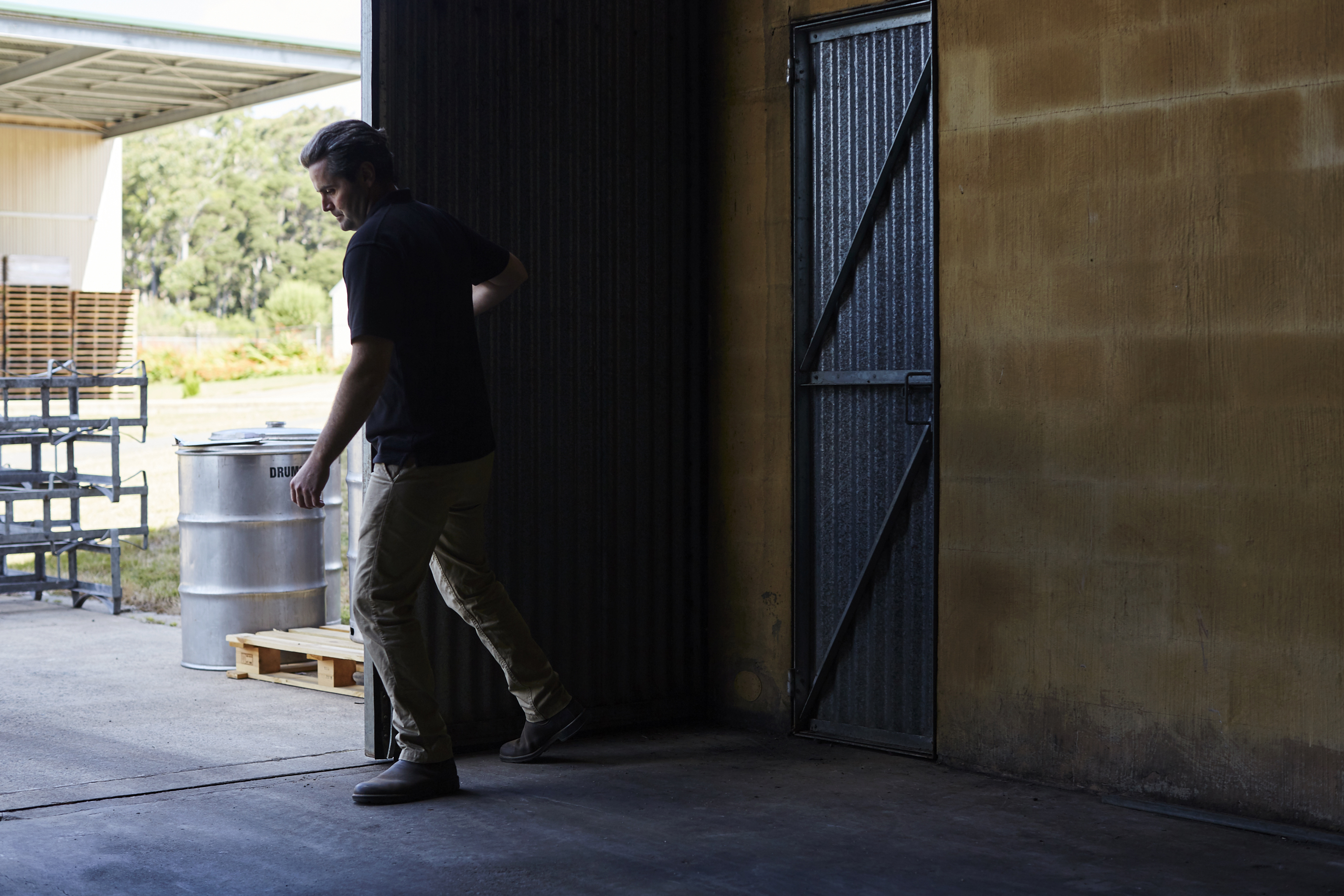 Man closing winery door